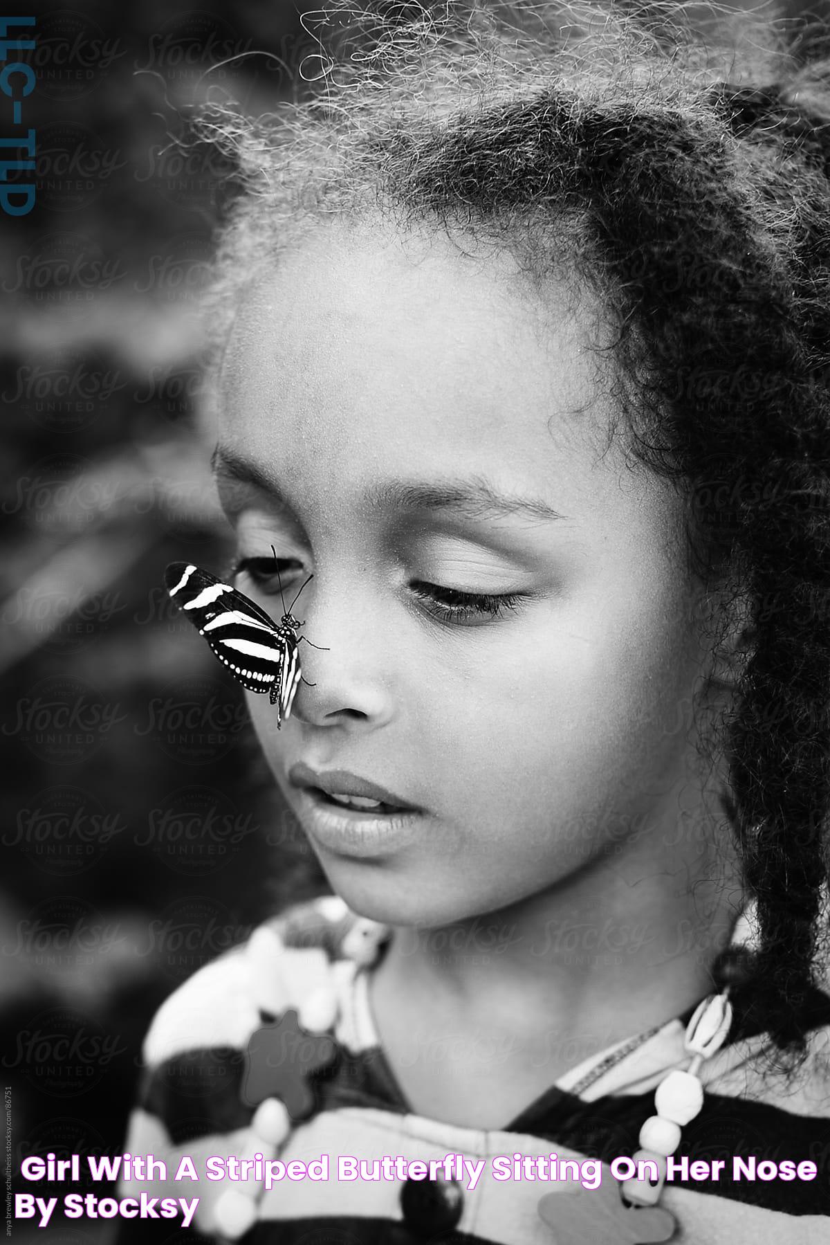 "Girl With A Striped Butterfly Sitting On Her Nose" by Stocksy